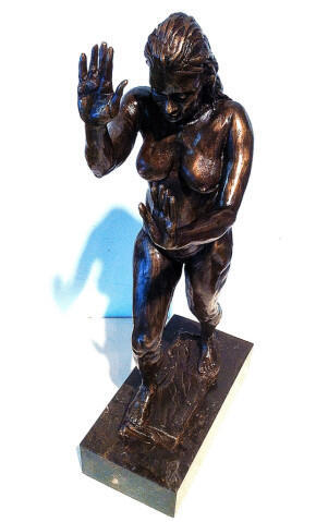 Bronze statue of a woman with her hand out in front of her. Set Me Free by Gerald Griffin